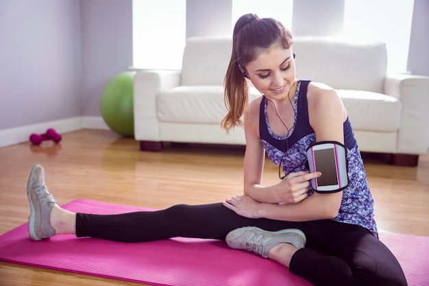 Fit woman stretching on exercise mat