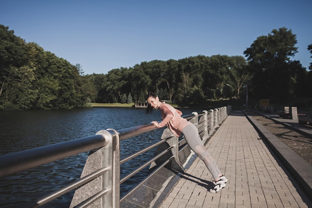 Fit woman in a tracksuit is preparing for run