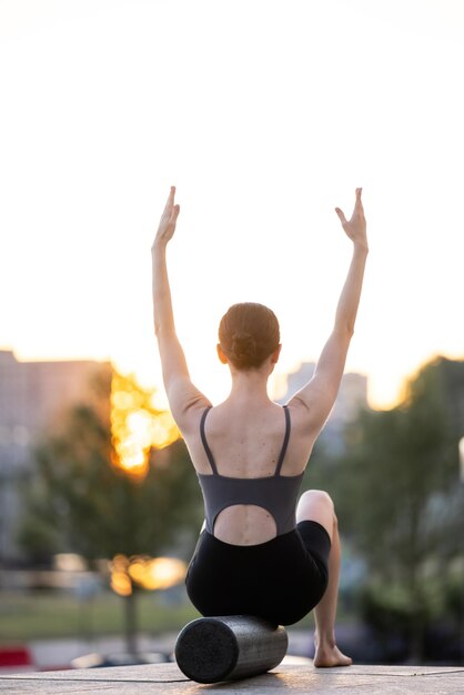 fit woman train with the foam roaller widely known as a rehab tool designed to smooth out fascia