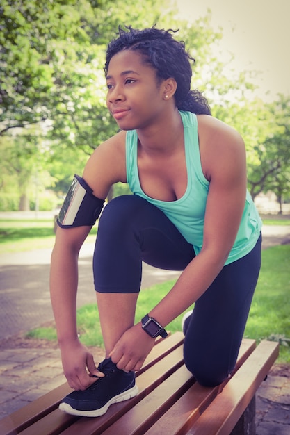 Fit woman tying her shoelace 