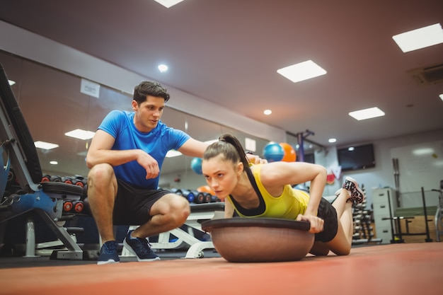 Fit woman working out with trainer