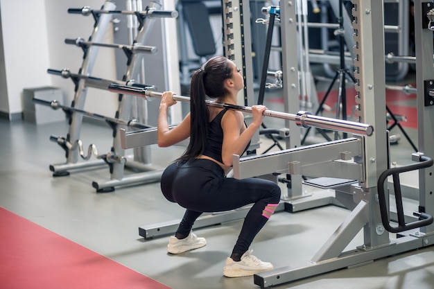 Fit woman working with barbell