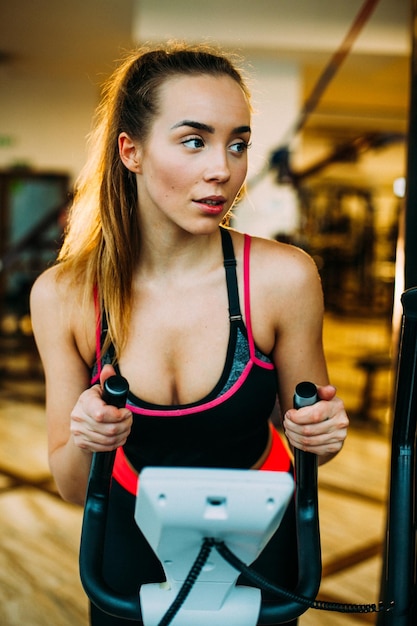 Fit women running on treadmills in modern gym