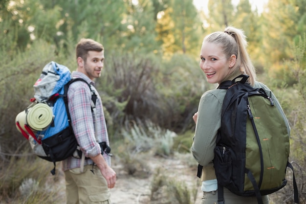 fit young couple exploring the woods
