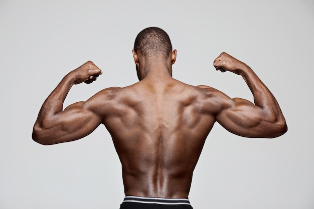 Fit young man with beautiful torso isolated on white background The naked torso of African American