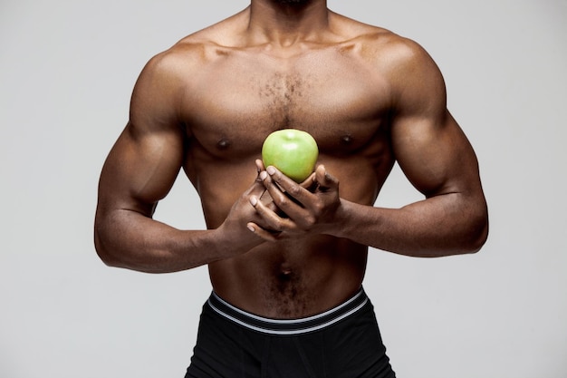 Fit young man with beautiful torso isolated on white background