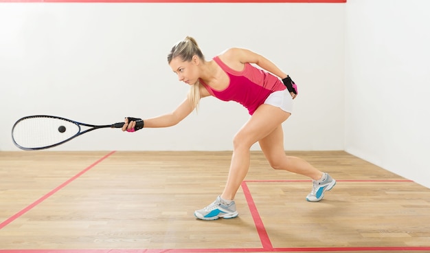 Fit young woman playing tennis