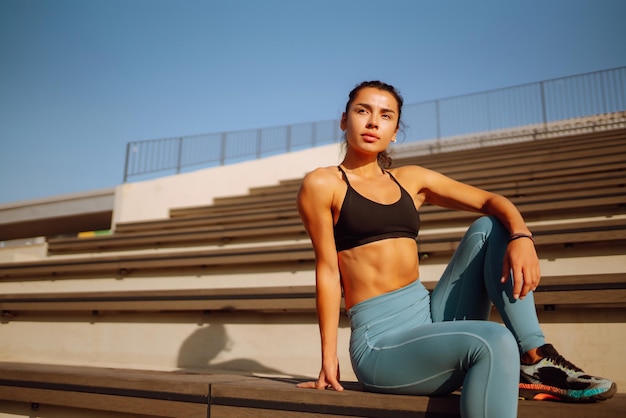 Fit Young woman in sportswear doing yoga fitness exercise on the street Sport Active life