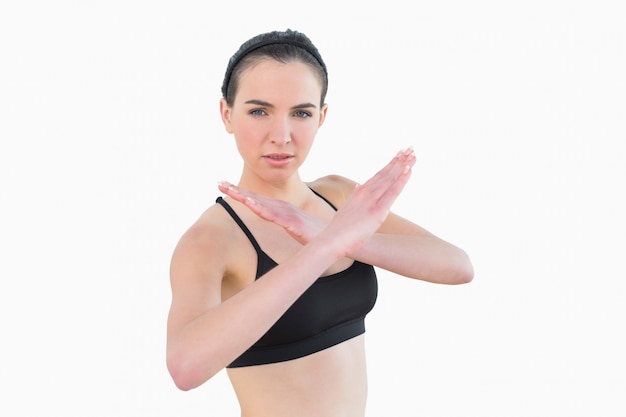 Fit young woman standing in defending posture