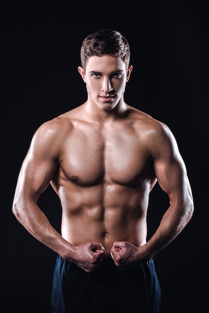 Fitness boy on black background