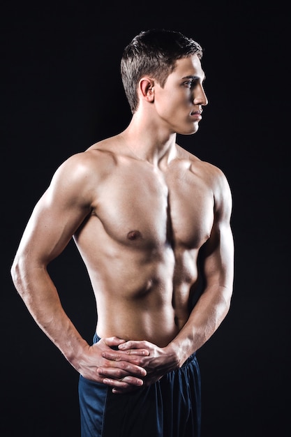 Fitness boy on black background