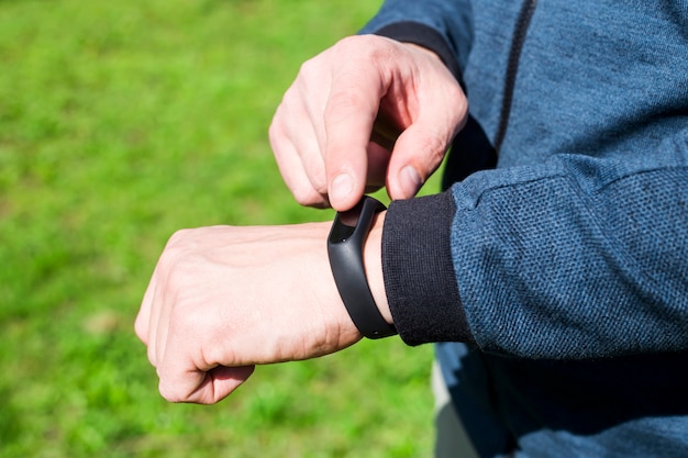 Fitness bracelet or smart watch on a man's hand