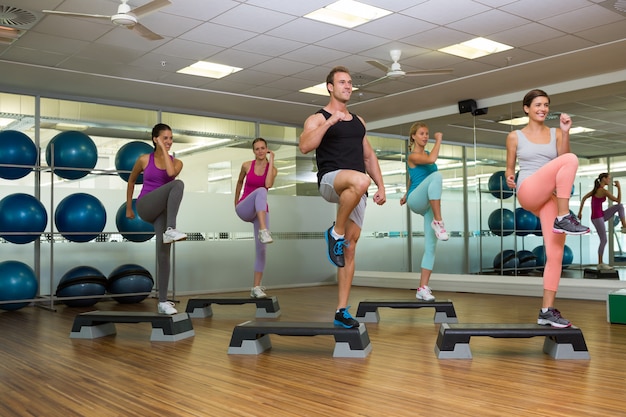 Fitness class doing step aerobics