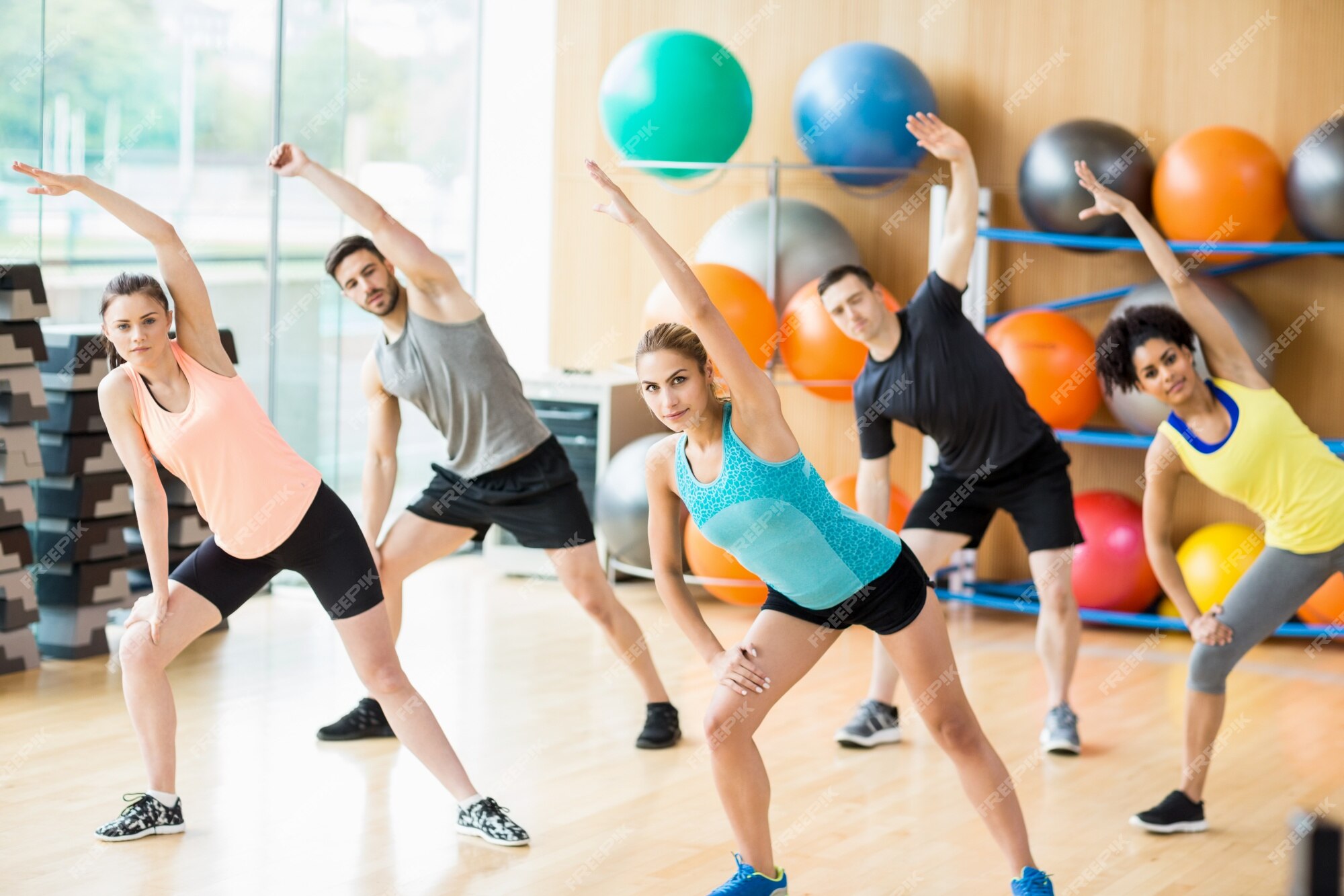 Premium Photo | Fitness class exercising in the studio