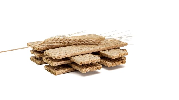 Fitness crispbread with ears of wheat isolated on white background. Healthy diet food. Whole grain crispy bread. Diet bread.