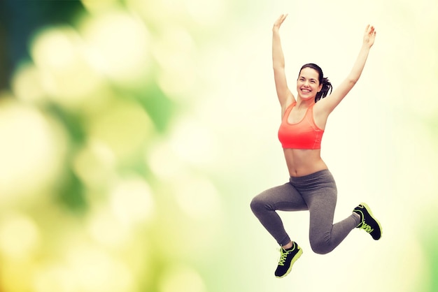 fitness and diet concept - beautiful sporty teenage girl jumping in sportswear