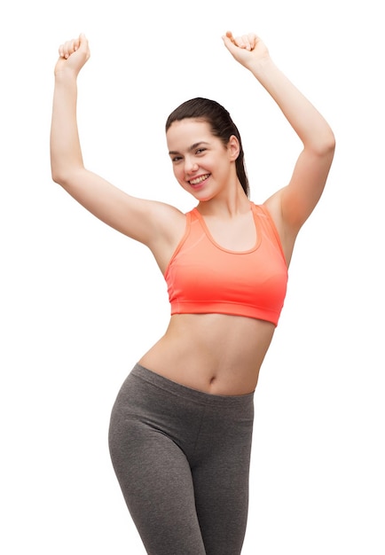 fitness and diet concept - smiling teenage girl in sportswear dancing