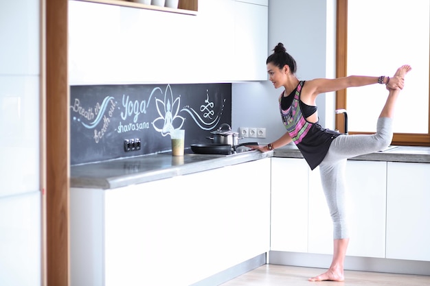 Fitness girl cooking healthy food in the kitchen