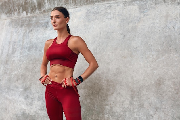 Fitness Girl Relaxing Near the Wall at the Street Woman In Fashion Sporty Outfit