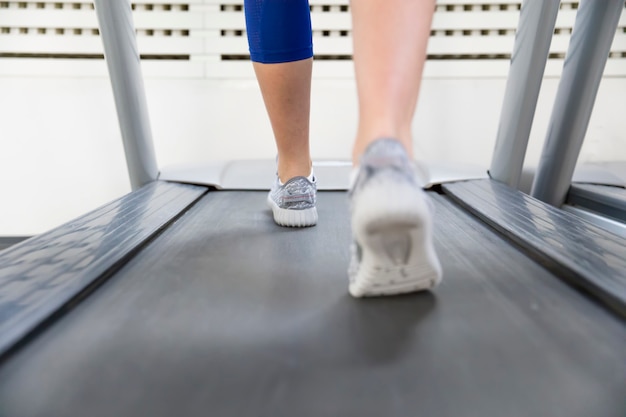 Fitness girl running on treadmill