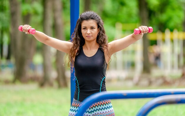 Fitness girl with dumbbells