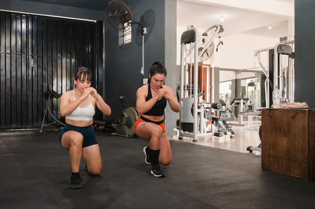 Fitness girls doing lunges in the gym