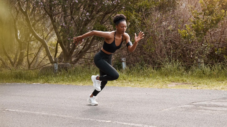 Photo fitness go and black woman running in a road for speed training action or body performance in nature start wellness and african girl runner in a street for marathon practice or cardio routine
