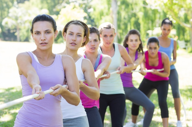 Fitness group playing tug of war