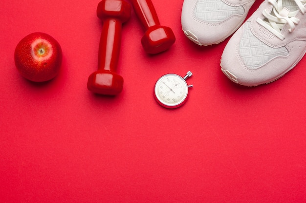 Photo fitness gym equipment on red color background