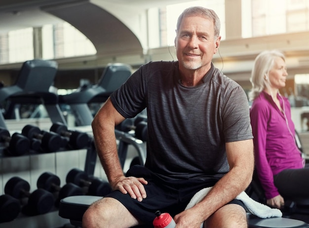 fitness gym and portrait of senior man with water bottle for training exercise and workout sports retirement and person with vitamins minerals and liquid for wellness health and