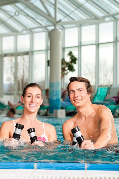 Fitness - gymnastics under water in swimming pool