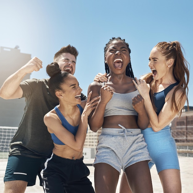 Fitness happy and friends in workout celebration in the city on a rooftop with achievement Diversity happiness and people celebrating sports victory for success motivation and outdoor exercise