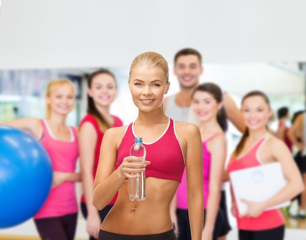 fitness, health and diet concept - sporty woman with bottle of water