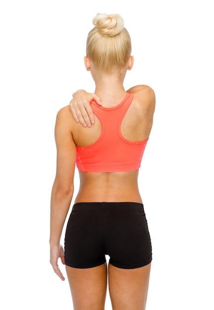 fitness, healthcare and medicine concept - sporty woman touching her shoulder