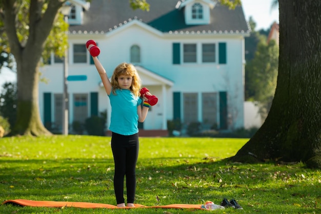 Fitness kind kinderen ochtendsport oefeningen jongen doet oefeningen om spieren te ontwikkelen kind doet