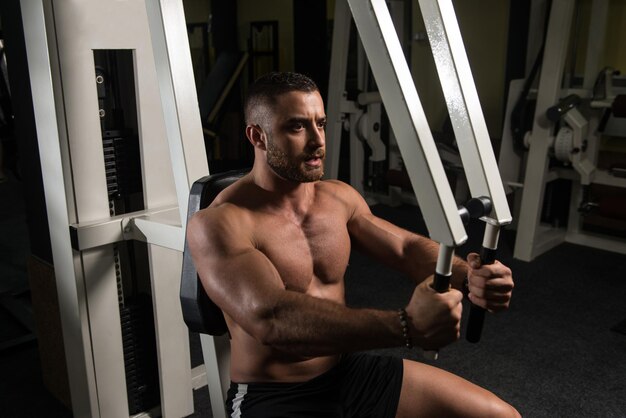 Fitness Man Exercising Chest In The Gym