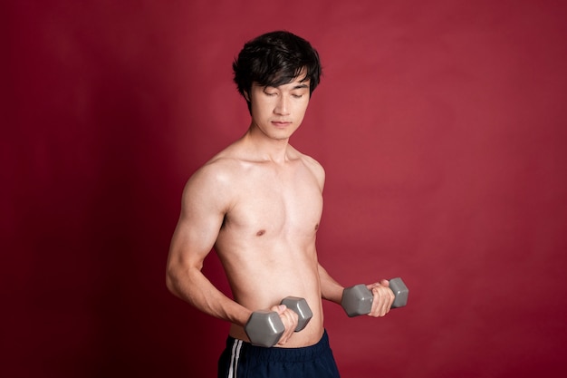 Fitness man on red background 