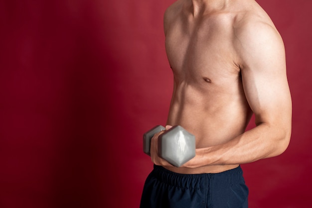 Fitness man on red background 