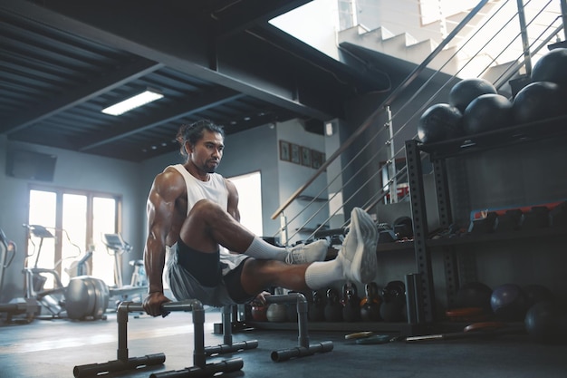 Fitness Man Standing at Hands Having Workout Exercises at Gym