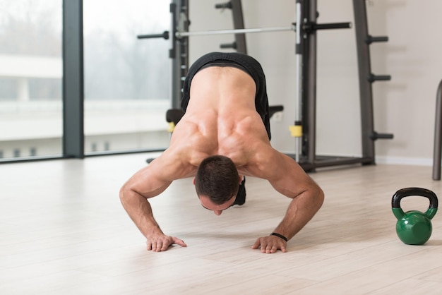 Fitness Man Stretches At The Floor