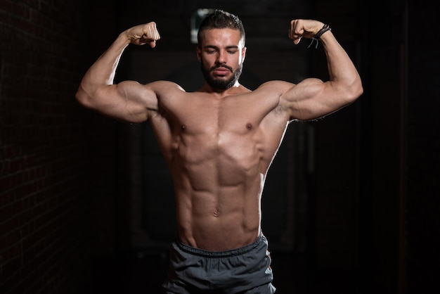 Fitness Model Posing Double Biceps After Exercises