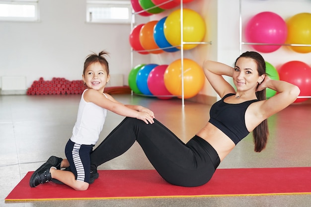 Fitness mother and child. Sports activities with children. Fitness center.