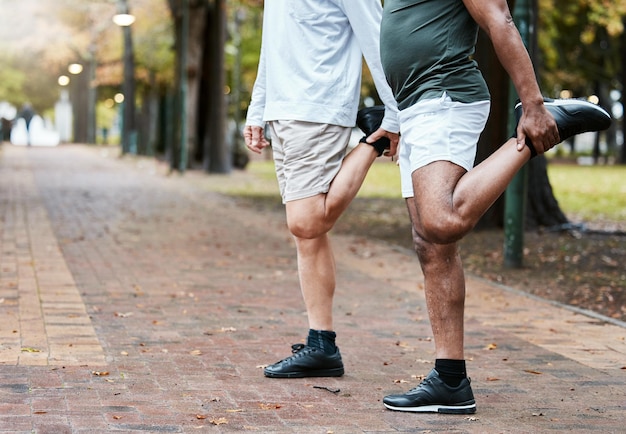 Fitness park and men stretching legs before running exercising and workout outdoors together Health wellness and friends doing exercise stretch and training for marathon sports and cardio