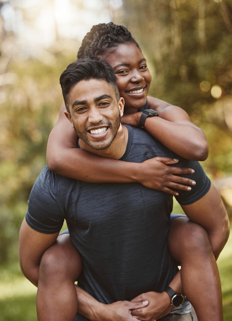 Photo fitness piggy back and portrait of couple outdoors for exercise training and running for cardio workout dating happy and interracial man carrying woman for wellness healthy body and sports