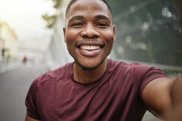 Fitness portrait or black man taking a selfie in a city for social media marketing online content or running exercise blog Face pictures or happy African runner smiles with pride or freedom