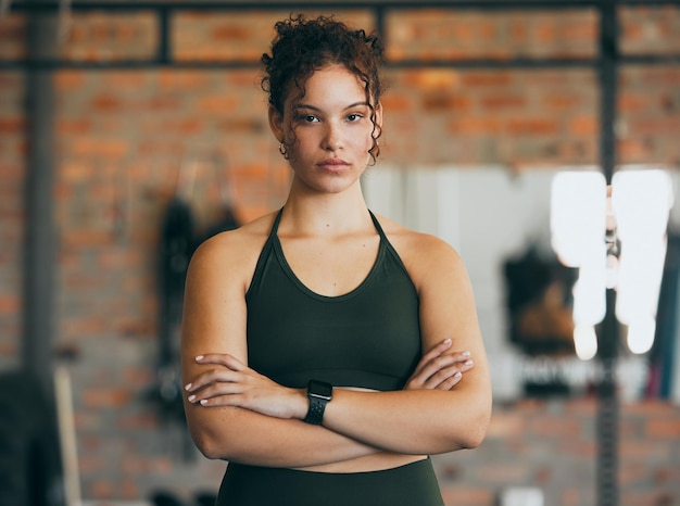 Fitness portrait exercise and serious woman at gym for a workout training and body motivation at health club Face of sports or athlete female focus on performance progress and healthy lifestyle