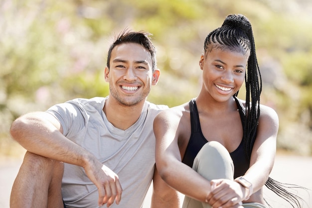 Fitness portrait and happy and diverse couple bonding after morning run relax and rest while sitting outside Smiling woman enjoying a healthy lifestyle with asian boyfriend cheerful and carefree