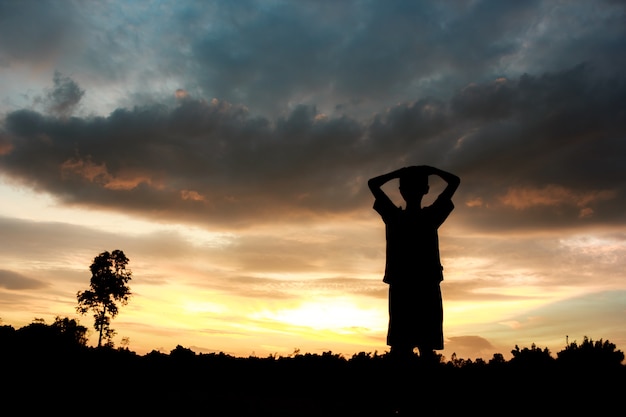 Fitness on silhouette sunrise The boy  workout wellness concept.