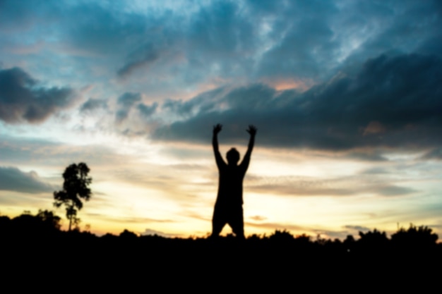 Fitness on silhouette sunrise The boy  workout wellness concept.