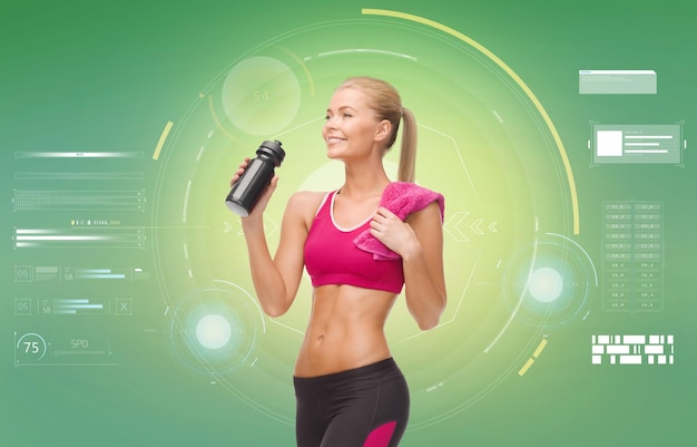 fitness, sport, exercising, slimming and people concept - smiling sporty woman with bottle of water and towel over green background